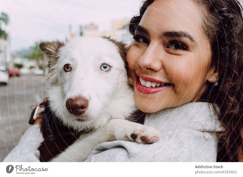 Happy woman hugging with dog border collie owner embrace friend animal pet together female canine heterochromia obedient friendly companion breed happy domestic