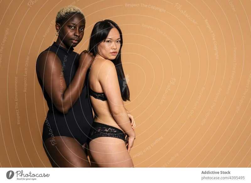 Tender diverse women in lingerie embracing in studio underwear body positive embrace hug model accept tender confident shape female multiracial multiethnic