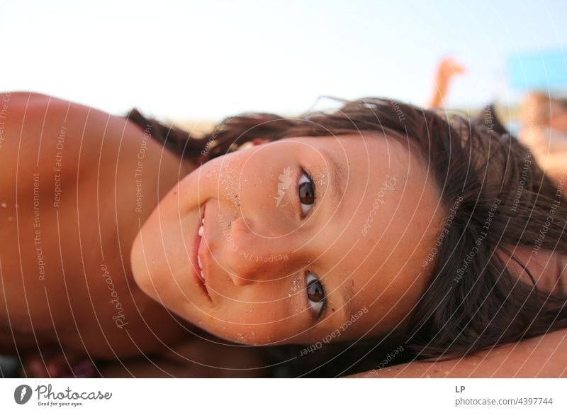 face of a beautiful child smiling at the camera positive emotion smile Ocean Beach Individual Isolated Single Abstract Movement Flow Children's game