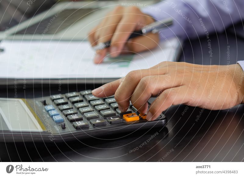 businessman hand pressing a calculator Business, finance, tax and investment concept. accounting financial calculate management money work accountant analysis