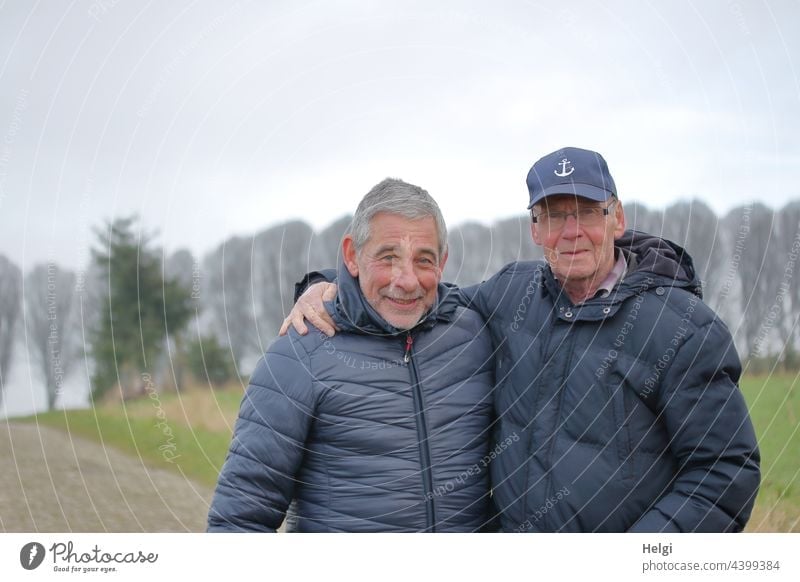 Friends - portrait of two friendly seniors in winter jackets outside in nature Human being Man Senior citizen Winter Jacket cap Gray-haired Facial hair