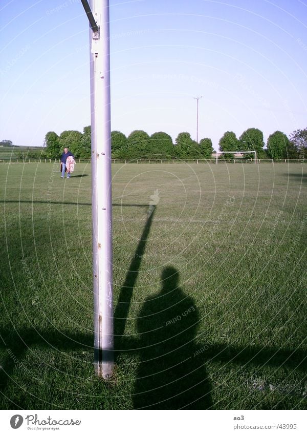 The spirit of football Playing field Meadow Tree Sunset Football pitch Green Shadow Gate Lawn Landscape Pole Ghosts & Spectres  Grass surface Exterior shot