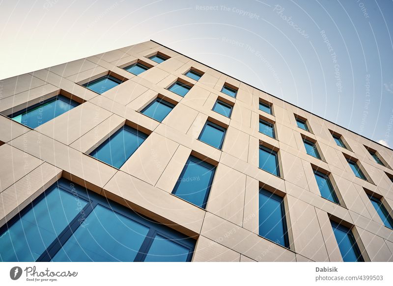 Facade of office building with windows modern architecture city construction condominium apartment exterior urban glass facade sky background business