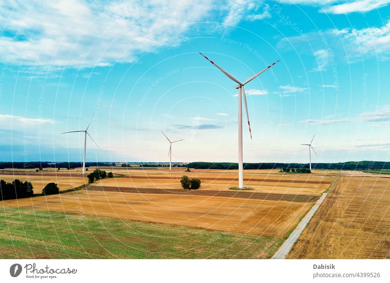 Windmill among agricultural fields. Wind turbine generator at summer day. Wind energy concept, Suistanable and renewable energy for climate protection windmill