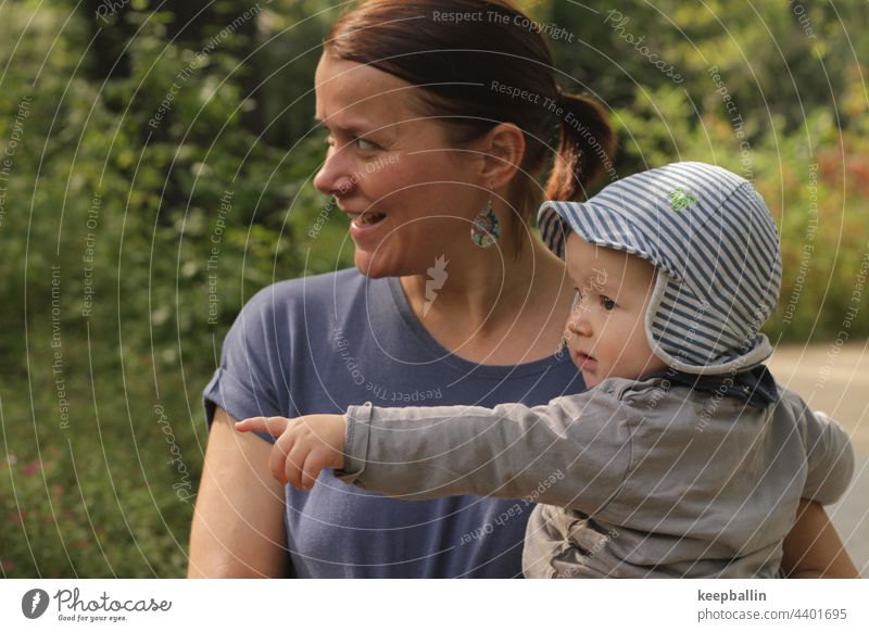 Mother with baby Woman Baby Child Boy (child) Cap arm Indicate Fingers Laughter cheerful Trip Carrying