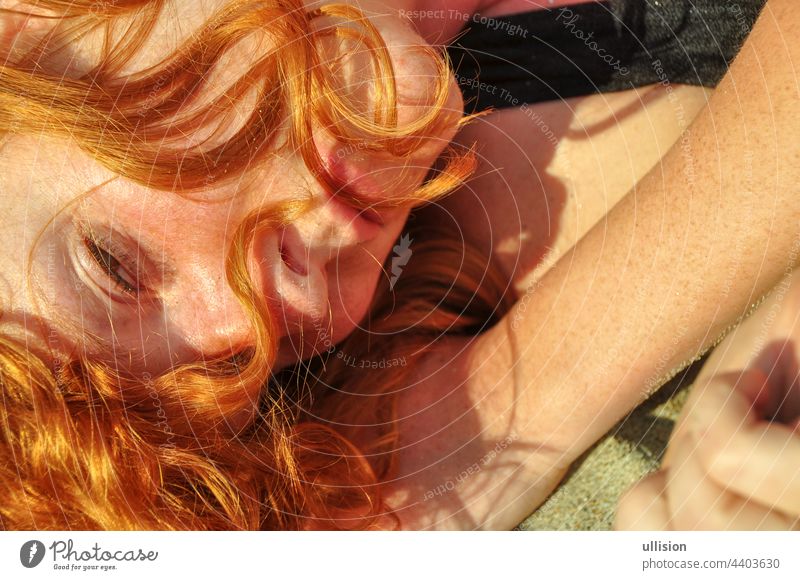 Beautiful portrait in closeup of a young elegant sexy red-haired curly woman on the beach full of love and desire Love Redhead Woman Lying Holiday Sea Italy