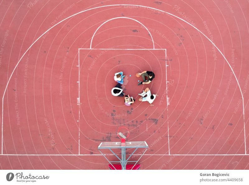 Above view of determined basketball playersstanding on court at daytime aerial background college competition field game grass green men outdoor outside person