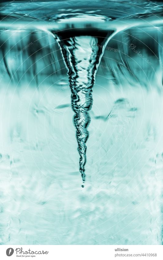 Cyclone demonstration in glass tube, tornado in water glass with rotating column of air, water tube with blue whirlpool abstract vortex freshness circular flow