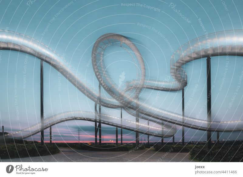 Artwork curved steel stairs in front of evening sky, long time exposure Work of art Stairs Steel Metal Arch curvy Tiger and Turtle Magic Mountain Round Landmark