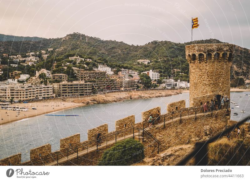 Photo of a beach on the Costa Brava taken from the top of a castle architecture blue build childhood city coast coastline destination europe fantasy fort