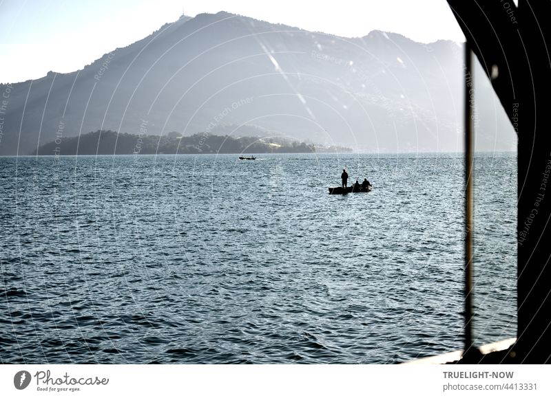 Anglers on the lake. The day has hardly begun. Petri heil I think. Lake Lucerne Switzerland mountains holidays vacation Fishing (Angle) boat boats Fishing boat