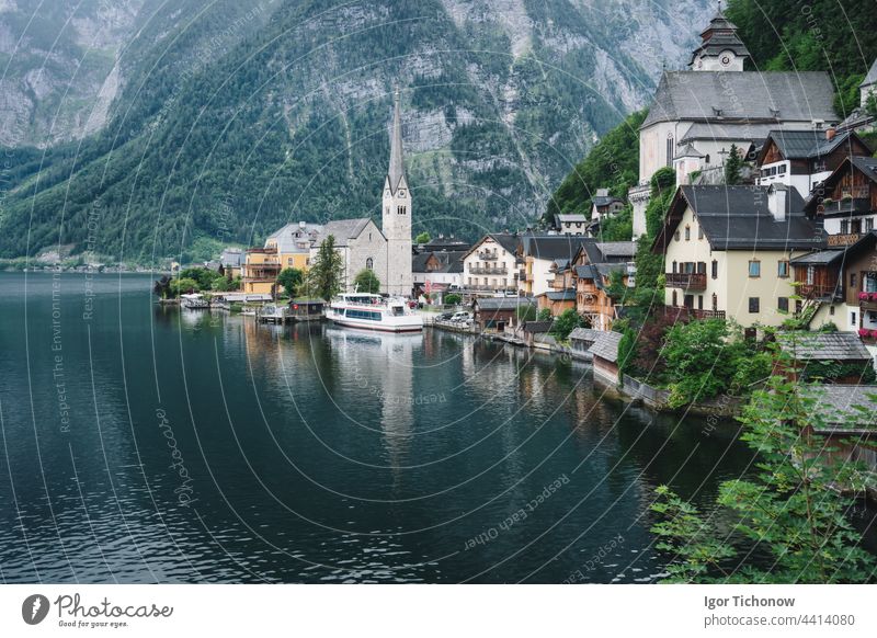 Famous lake side view of Hallstatt village with Alps behind, Foliage leaves framed. Austria hallstatt austria alps famous town landscape nature tourism