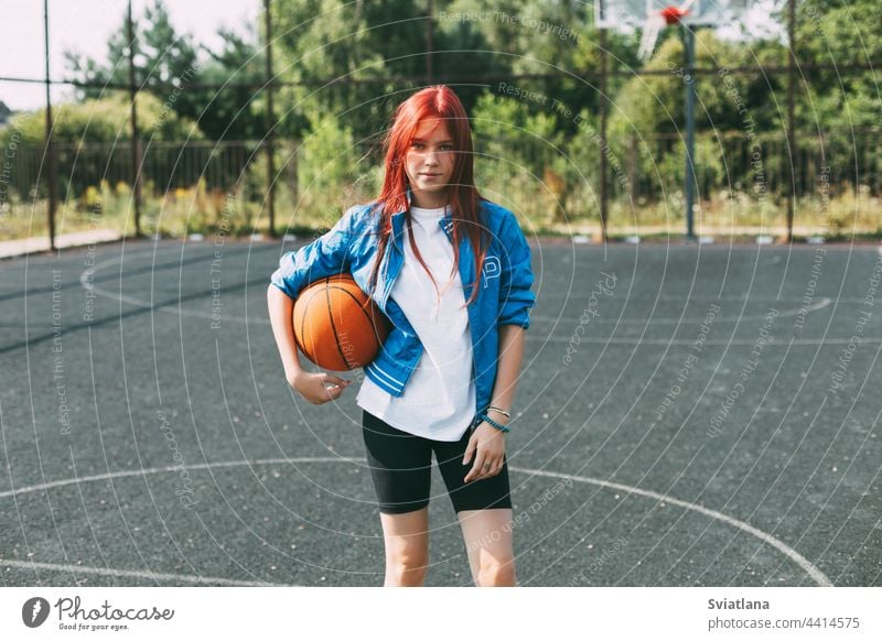Portrait of a smiling teenage girl with a basketball on the sports field. Sports, health, lifestyle playground holding portrait player active activity leisure
