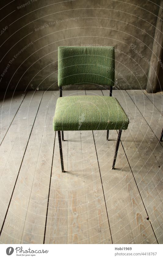 Green chair on a wooden floor lit from the side Chair Wood hall Floorboards interior equipment Room Wall (building) Old Dust Dusty Sit Seat inboard Cloth