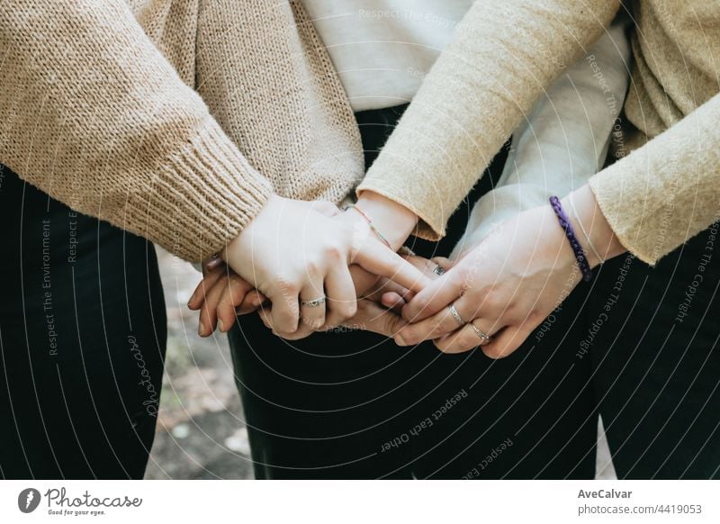 Hand of 3 persons touching together, friendship care and love concepts, copy space holding hands support togetherness happiness agreement meeting cooperation