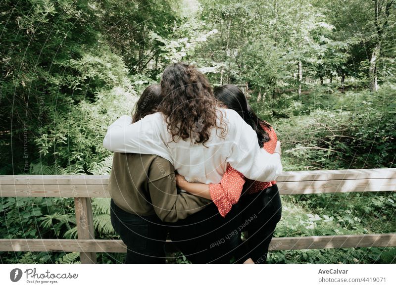 Three woman hugging each other, love and affection concept, forest, friendship and care concept women young adult enjoyment equality horizontal laughing