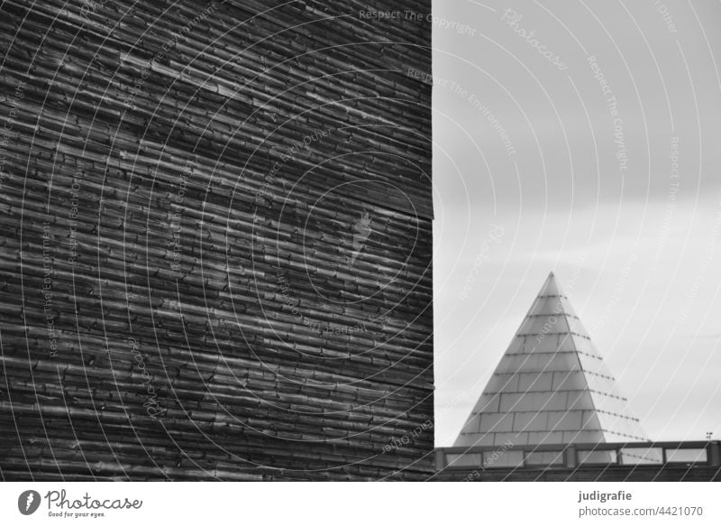 Structured facade next to glass pyramid Architecture Facade Pyramid Glass Modern Point Triangle surface Building Manmade structures lines geometric Design