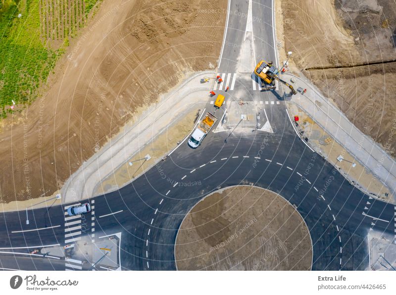 Aerial view over construction site, finishing work, new traffic roundabout Above Active Architecture Asphalt Building Site Car Circular Civil Engineering