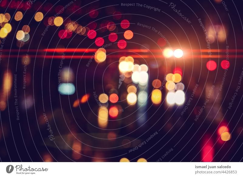 defocused multicolored street lights at night in the city colors colorful bokeh circles bright shiny blur blurred outdoors abstract pattern background glow