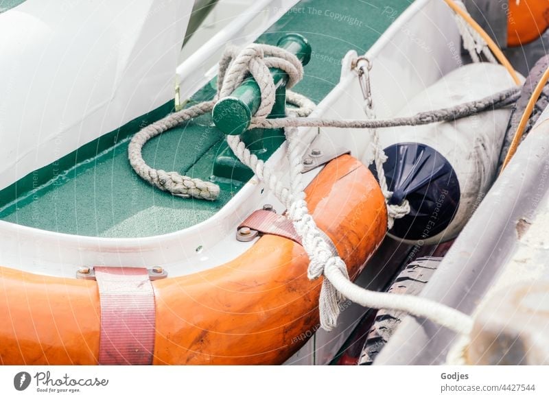Partial view of a boat at the harbour Freest Rope Rescue Coastal patrol Orange Green White Black Exterior shot Colour photo Deserted Red Day Navigation Safety