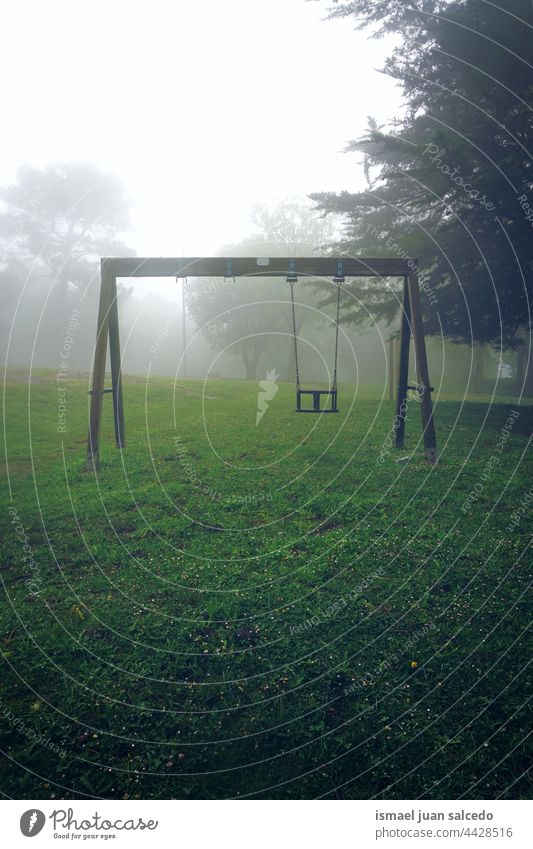 old abandoned swing in the mountain playground playing playtime playful fun park public park street outdoors childhood cheerful colors colorful bilbao spain fog