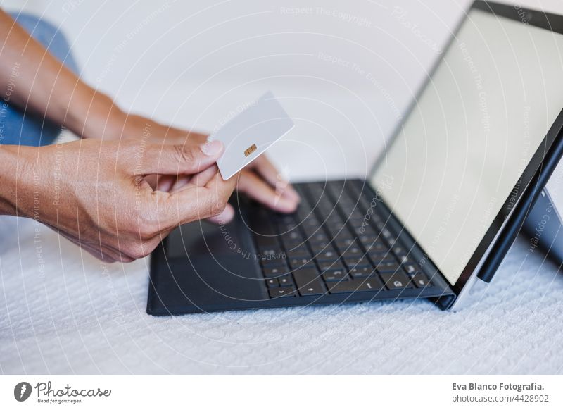 close up of unrecognizable woman doing online shopping with credit card and laptop. Technology and business concept caucasian human computer electronic bank