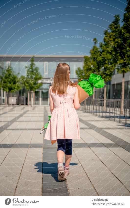 A girl goes to school with a school bag for enrollment Girl School candy cone sugar cone First day at school Child Colour photo Infancy Education Study