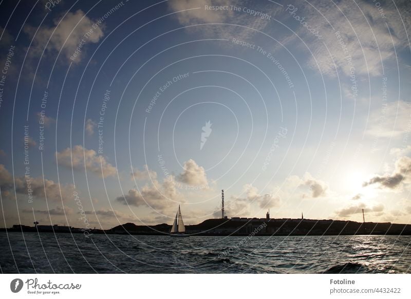 A sailboat drifts off the coast of the island of Helgoland. Sailboat Water Watercraft Sailing Sky Ocean Summer Vacation & Travel Navigation Sailing ship Freedom