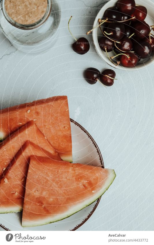 Bunch of summer and fresh fruits over a minimalist white table, watermelon and cherry, wellness and healthy food concepts, tasty , textured, copy space artist