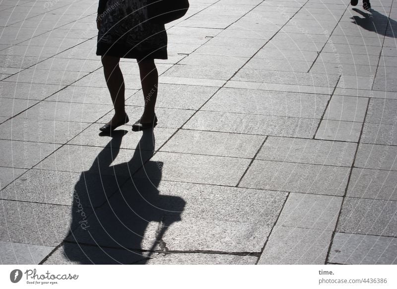 on the way Silhouette Shadow urban Woman sunny Concrete slabs Floor covering Places In transit crossing Back-light