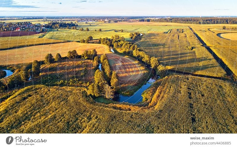 Sunny autumn landscape. Meadows, river, village, dirt road Belarus. Corn harvest. field september aerial agriculture corn panorama countryside farm view outdoor
