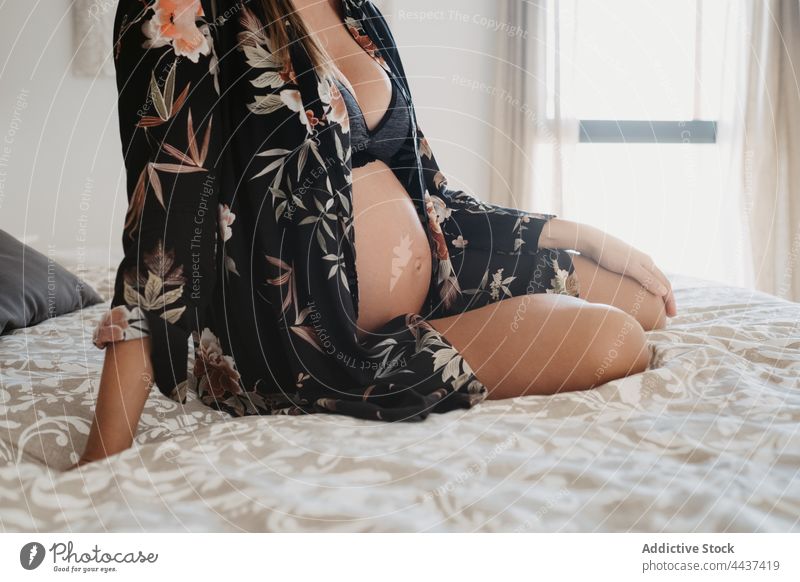 Pregnant female in underwear lying on bed - a Royalty Free Stock Photo from  Photocase