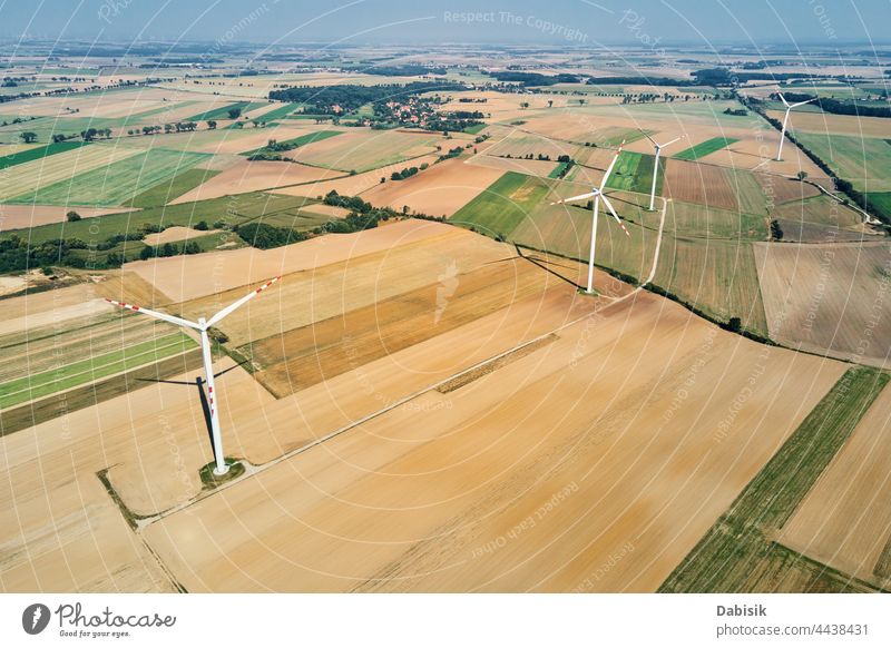 Windmill turbine in the field at summer day. Rotating wind generator energy windmill technology propeller sustainable landscape eco electric concept industry