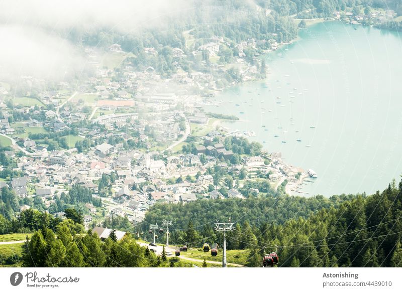 View of St. Gilgen Weather Fog Town Vantage point Lake Lake Wolfgang Cable car location Austria boats Forest Nature Landscape houses wide off Alps mountains