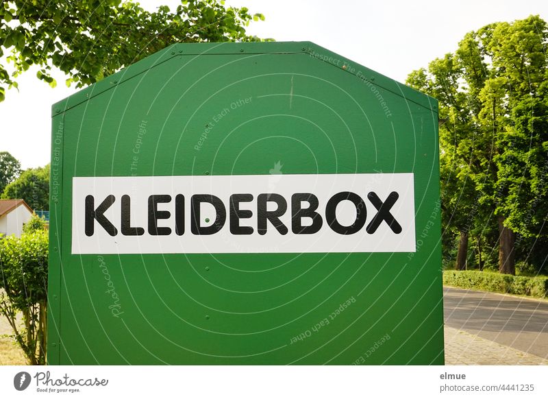 green metal container with the inscription KLEIDERBOX / Textilrecycling standing on a street Clothes box Old clothes Kiloware non-profit Textile recycling