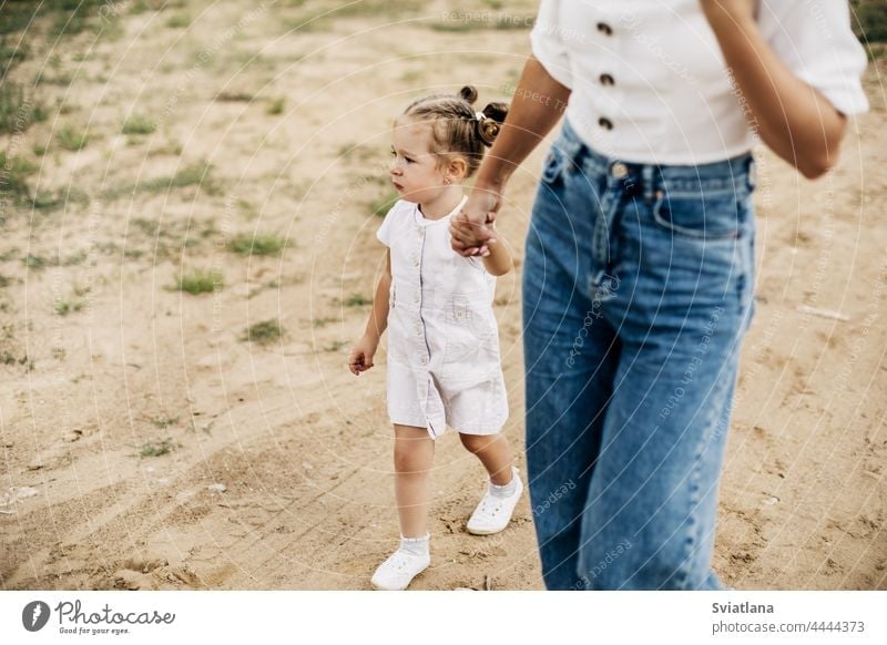 father and daughter holding hands walking