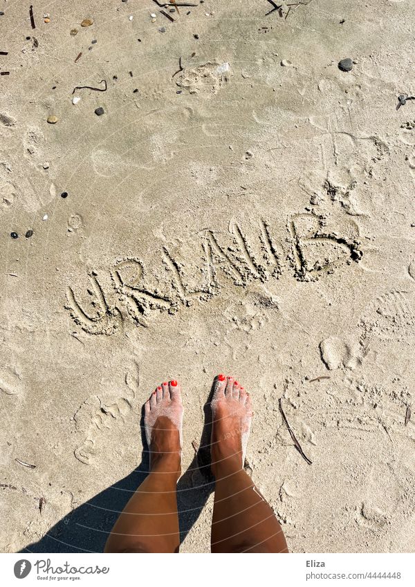 Feet standing on the beach in front of the word holiday written in the sand. vacation Sand Beach Vacation & Travel beach holiday Summer Summer vacation feet