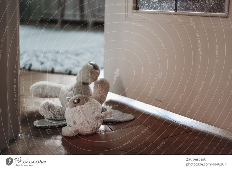 Teddy bear lies in half open door to children's room Toys Children's room Lie Infancy Fear Abuse material Sadness sad Loneliness Grief Tidy up disorder