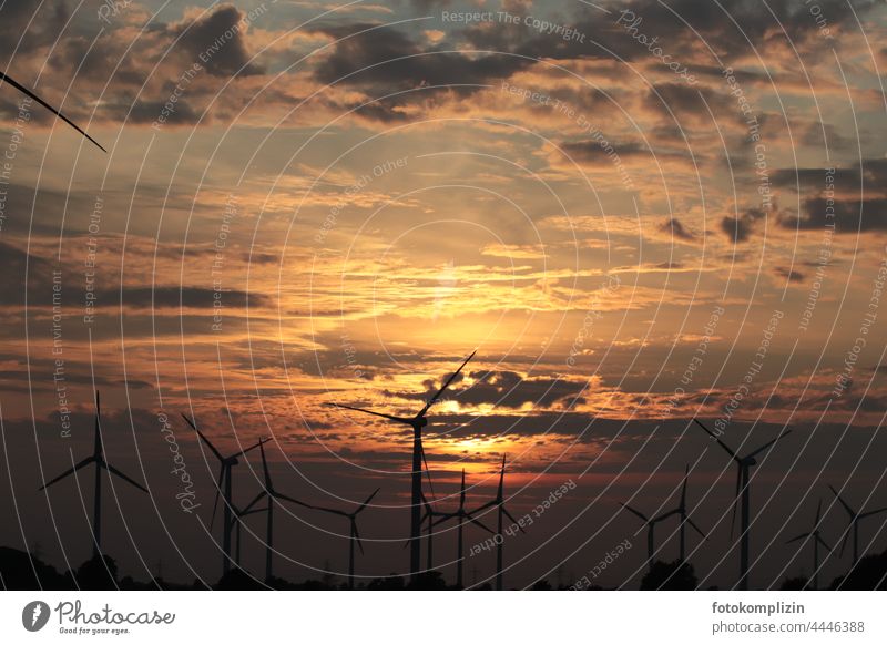 Wind turbine under a red cloudy sky Wind energy plant wind turbine Pinwheel Power grid Energy wind power Renewable energy Sky Electricity Energy industry