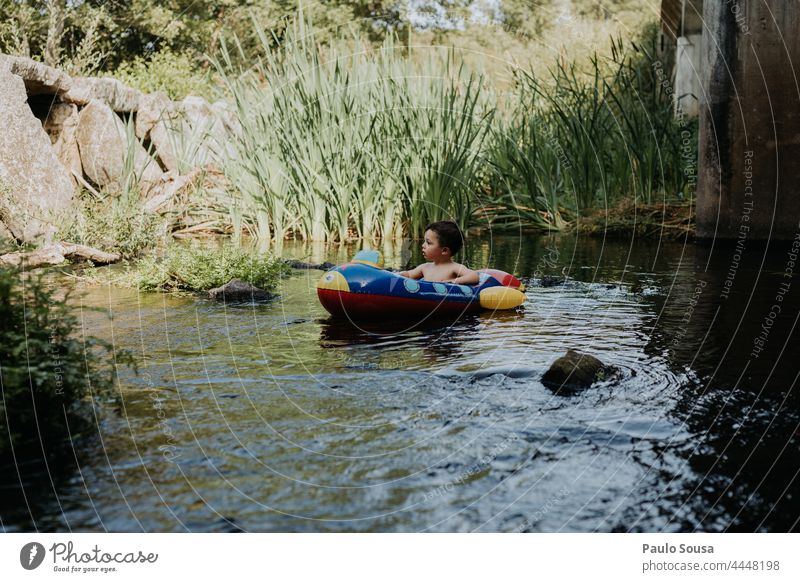 Child on inflatable boat Inflatable childhood Summer River water summer kid cute leisure happy vacation smile holiday outdoors young cheerful lifestyle