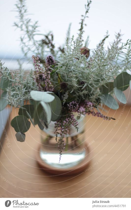 small bouquet of flowers with eucalyptus leaves Ostrich Bouquet Bright green heather flower water Vase glass Decoration ornamental Light Window Window board