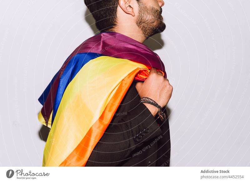 Anonymous man arrying LGBT flag rainbow symbol right community union tolerance respect male optimist homosexual positive play solidarity multicolored identity