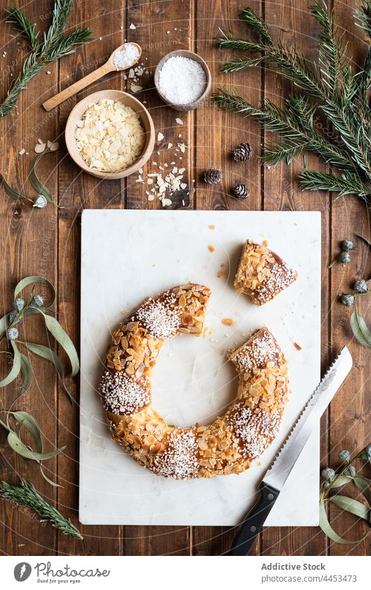 King cake with almond petals and shredded coconut king cake dessert treat sweet tasty epiphany feast celebrate delicious holiday piece sprig eucalyptus fir