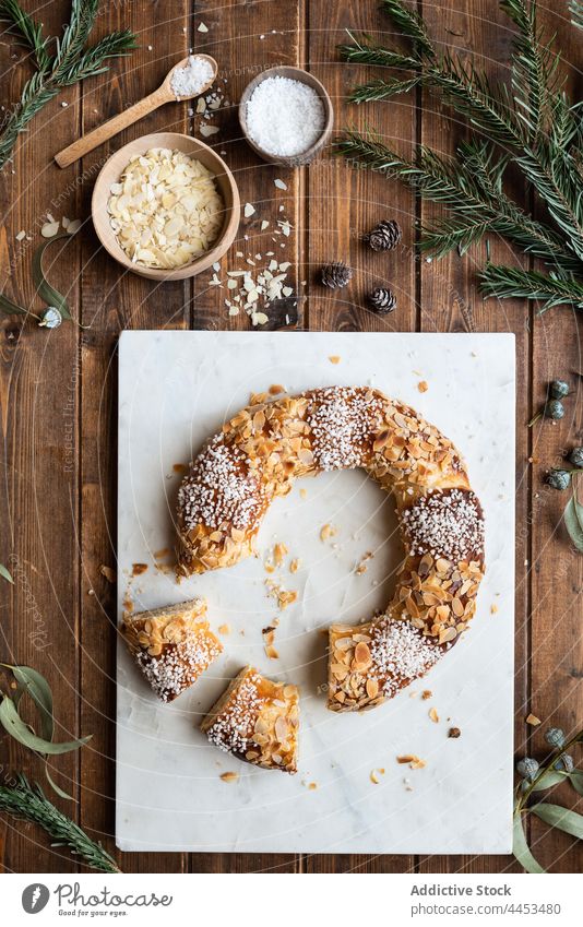 King cake with almond petals and shredded coconut king cake dessert treat sweet tasty epiphany feast celebrate delicious holiday piece sprig eucalyptus fir