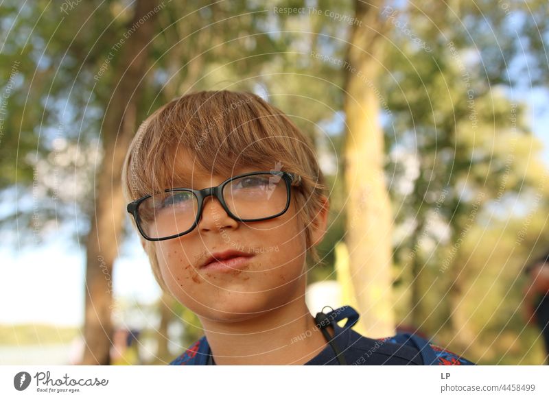 face of a beautiful child wearing glasses and with his mouth covered in chocolate Individual Isolated Single Abstract Flow Children's game Childhood memory