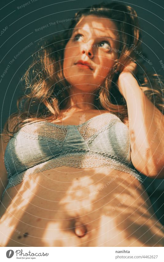 Body positive portrait of a young woman with light and shadows body atractive real plus size sexy long hair bra underwear natural real people real body