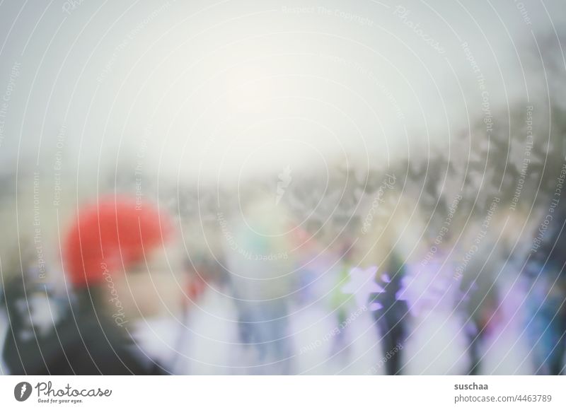 blurred scene with people at a winter ice rink with star bokeh Hazy Star Bokh Silhouette human head red cap Cold Scene persons Human being Head Winter scene