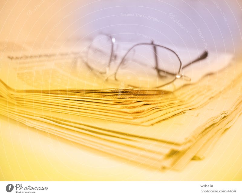 newspaper Eyeglasses Newspaper Yellow Photographic technology Blue Business
