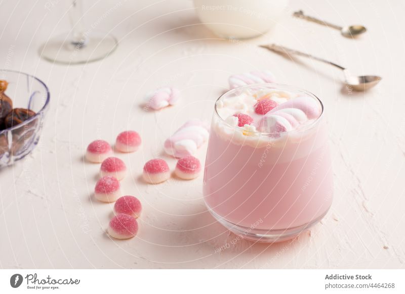 Glass of hot white chocolate jelly candy sweet drink marshmallow dessert delicious food confectionery yummy sugar tasty pink color flavor calorie glass