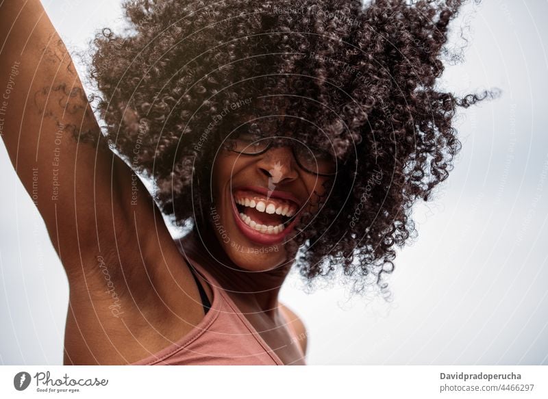 Happy ethnic female with curly hair woman happy african american hairstyle wild joy santo antao cape verde cabo verde young laugh excited joyful cheerful